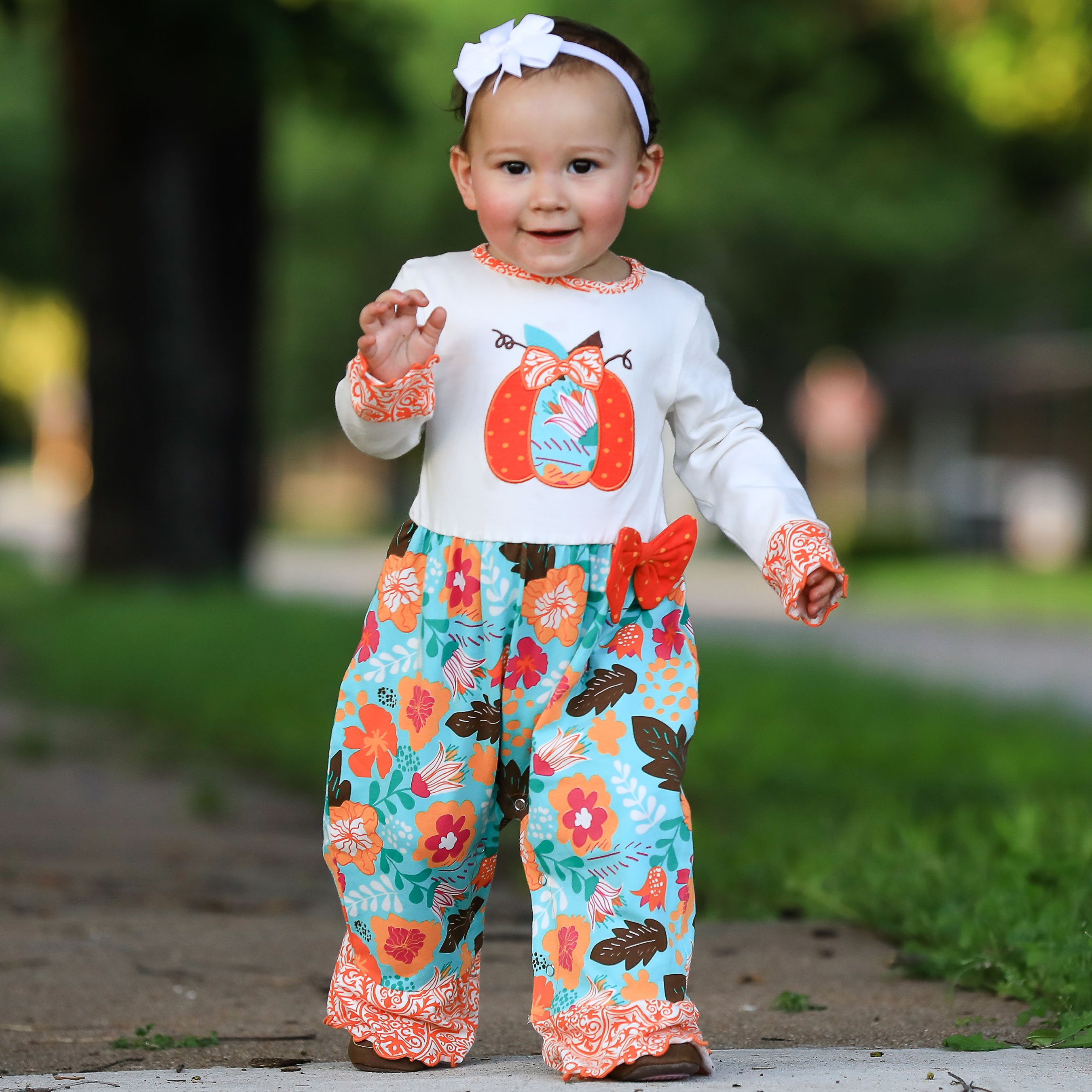 AnnLoren Baby Toddler Girls Pumpkin Romper in soft cream knit with floral prints and pumpkin embroidery.